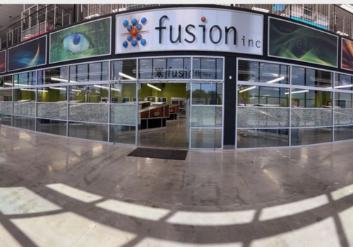 Professional janitorial cleaner wiping surfaces in a modern Iowa office building